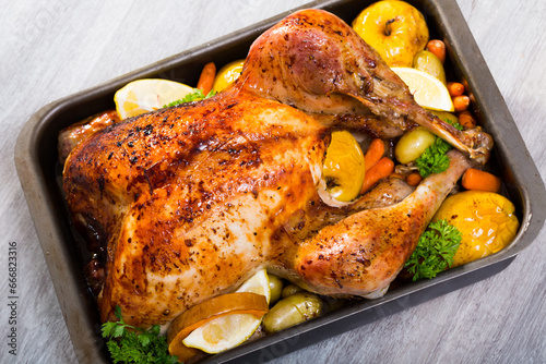 Garnished turkey. Rub turkey with salt, pepper, provencal herbs, honey and balsamic. Covered with foil turkey cook in oven 2 hours at 180 g. Pull off foil, put apples, vegetables and cook 40 minutes.