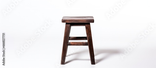 Backless stool made of dark brown wood isolated on white background