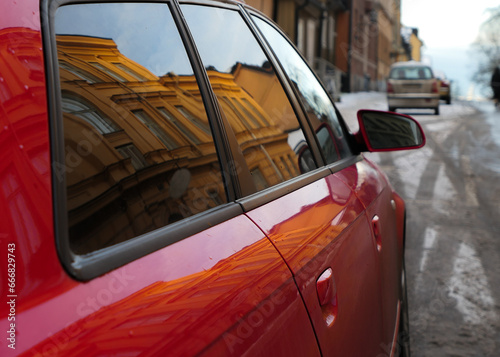 Close up of red car on road