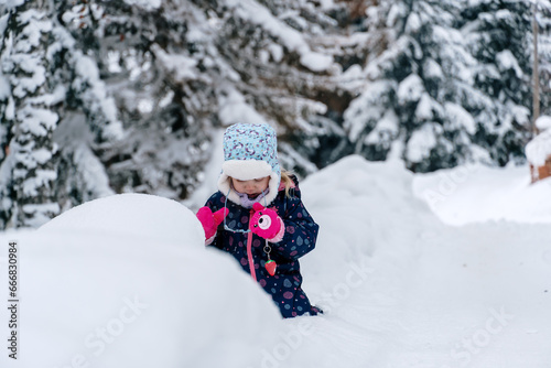 Little girl playing in a deep snow