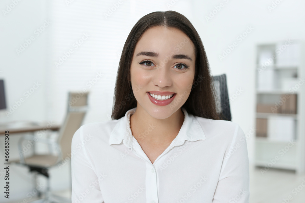 Portrait of beautiful young woman in office Portrait of beautiful young woman in office