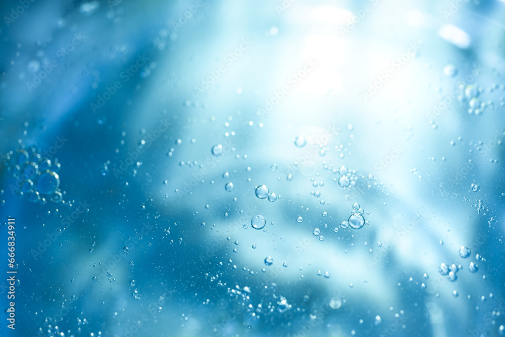 Fototapeta premium Air bubbles in the water background.Abstract oxygen bubbles in the sea.Water bubbles isolate on blue background.