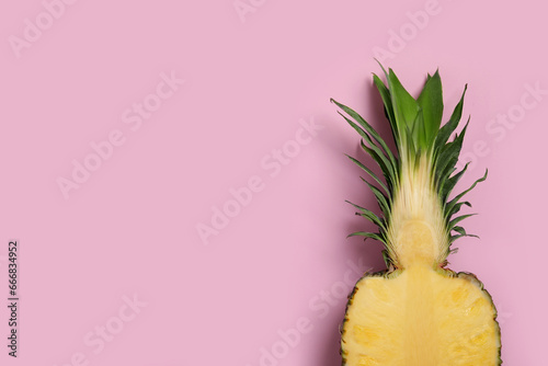 Half of ripe pineapple on pale pink background, top view. Space for text