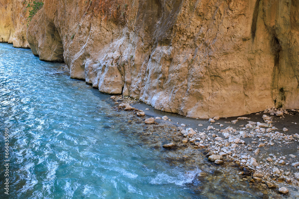 Naklejka premium Saklikent Canyon in Turkey with mountain cold stormy water in the river. Natural attraction, popular place for tourists