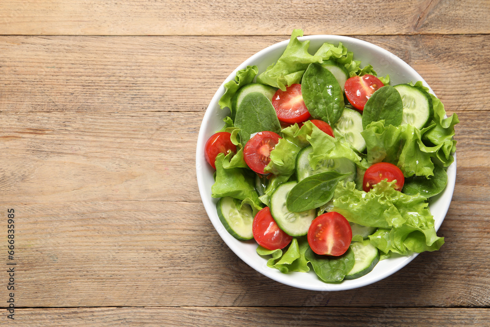 Delicious vegetable salad on wooden table, top view. Space for text Delicious vegetable salad on wooden table, top view. Space for text