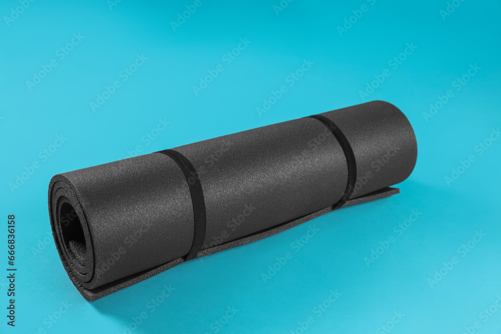 Grey yoga mat on light blue background Grey yoga mat on light blue background