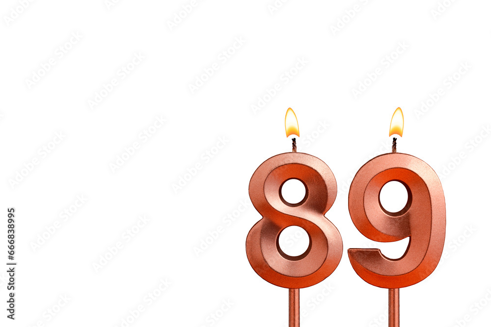 Burning candle number 89 for birthday on white background Burning candle number 89 for birthday on white background