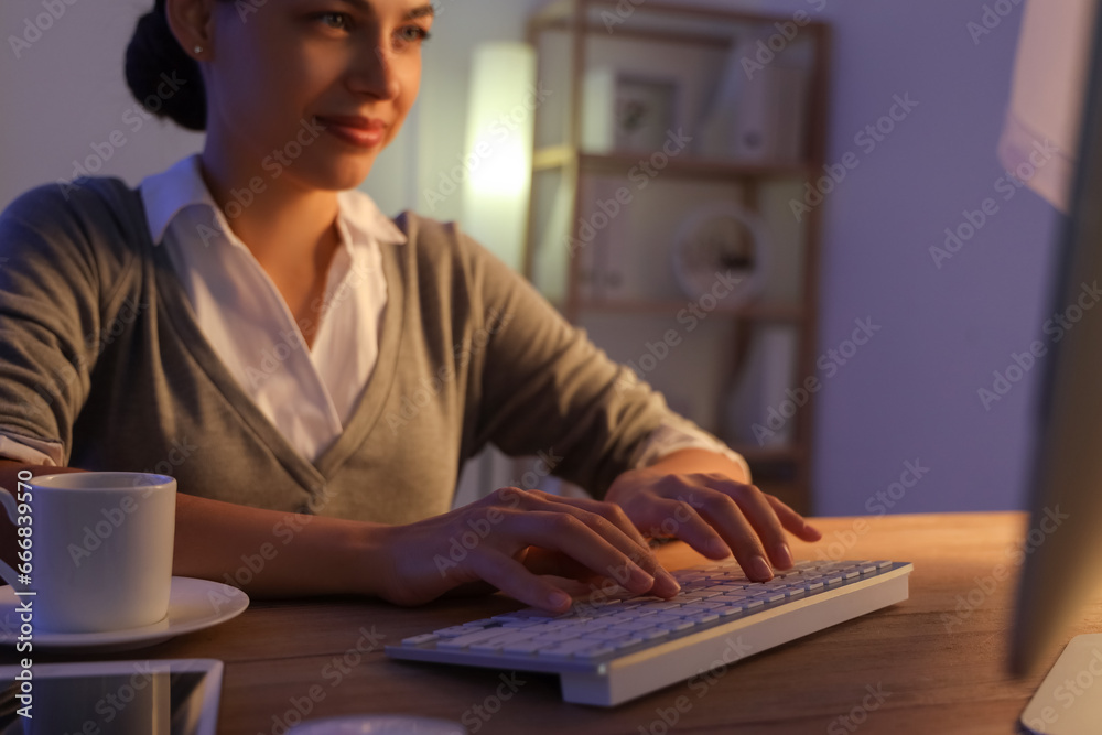Pretty young female programmer working in office at night Pretty young female programmer working in office at night