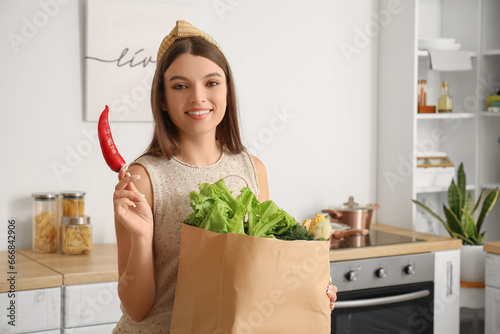 Young woman with paper bag ...