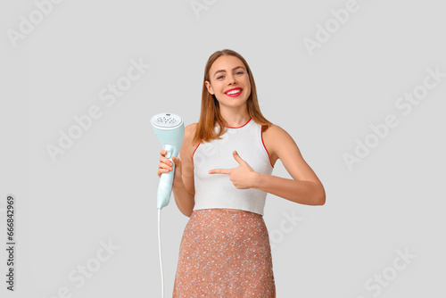 Young woman pointing at ste...