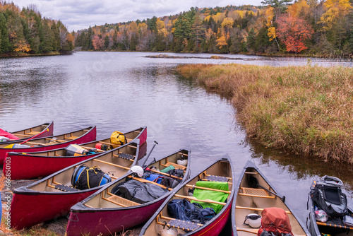 canoes pulled up on an island in the madawaska river ontario in fall with autumn color photo