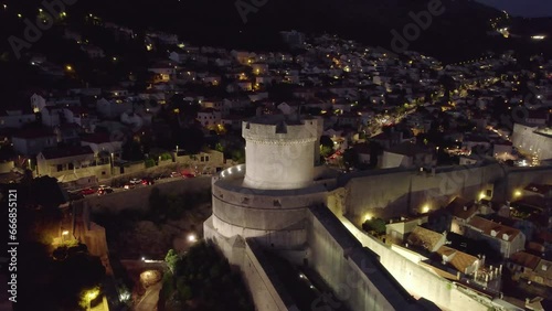 Aerial Dubrovnik at night: Tvrđava Minčeta tower and illuminated cityscape photo