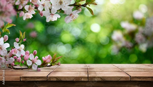 spring time background with wooden planks in the garden blossoms on a table in a beautiful green garden with a blurred bokeh generative ai season banner flowers on green background cherry blossom