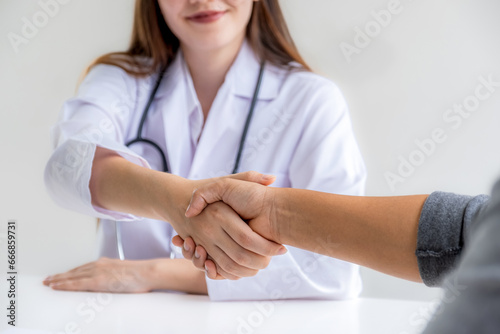 handshake after Doctors advice report health examination results and recommend medication to patients, occupational consultation medical checkup program concept