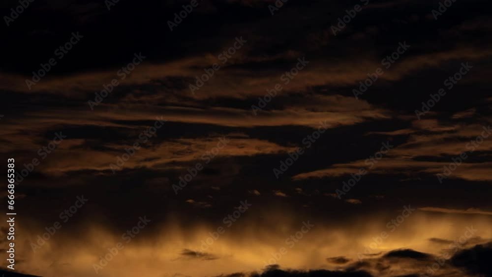 Time lapse of the beautiful scenery of the sunset sky with the golden rays of the sun against the background of the silhouette of the mountain landscape. Natural landscape background. Time lapse of the beautiful scenery of the sunset sky with the golden rays of the sun against the background of the silhouette of the mountain landscape. Natural landscape background.