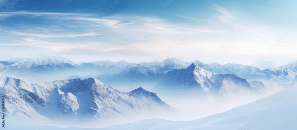 Fototapeta premium Cloudy sky over a wintery mountain scene