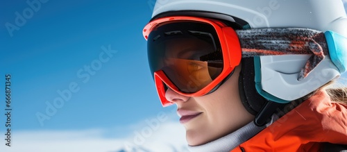 Alpine skier enjoying winter sport on mountain slopes in skiing gear and admiring the view