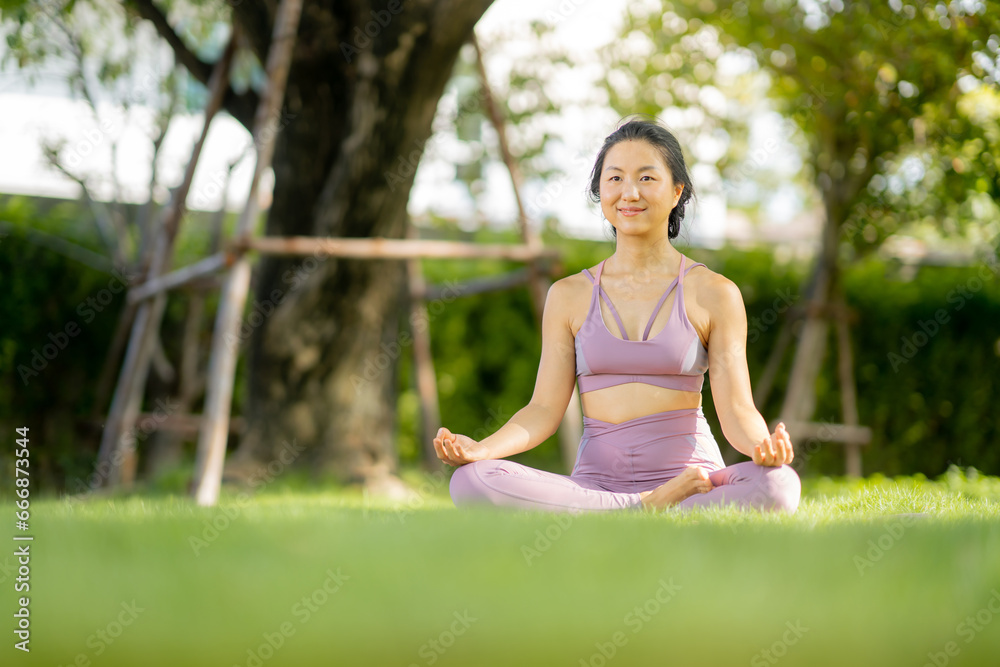 Asian woman wearing yoga clothes doing yoga at her village garden in the morning, happily, Sports healthy lifestyle concepts, Japanese concepts. Asian woman wearing yoga clothes doing yoga at her village garden in the morning, happily, Sports healthy lifestyle concepts, Japanese concepts.