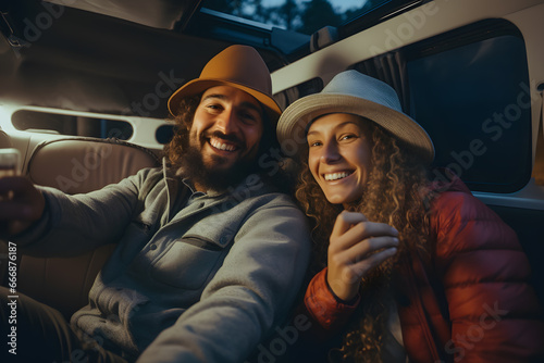 couple traveling in a camper van and taking pictures