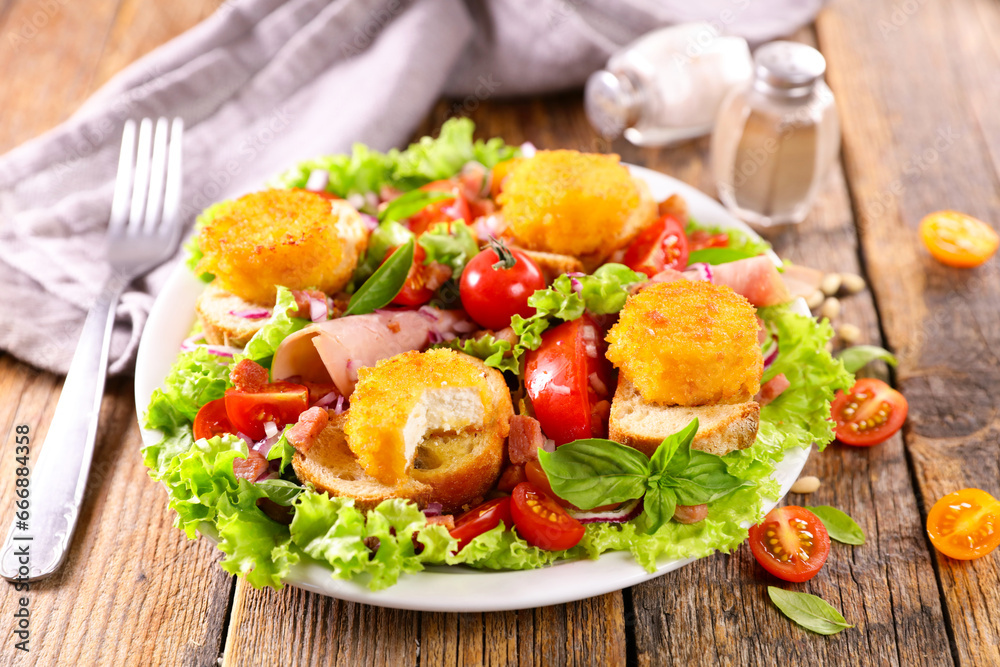 vegetable salad with bread toast and goat cheese