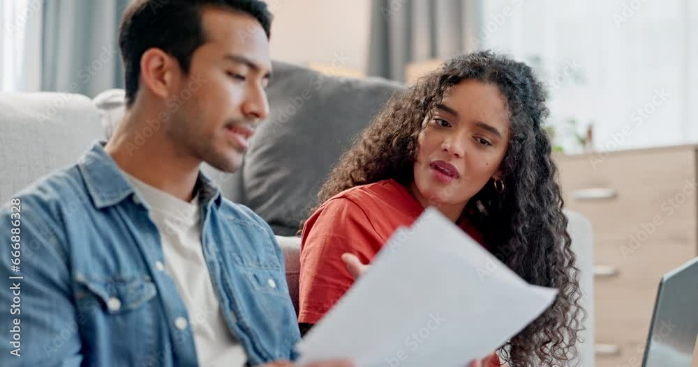 Paperwork, payment and couple in discussion in the living room for finance bill, debt or mortgage. Conversation, budget and young man and woman talking with financial documents in lounge at home. Paperwork, payment and couple in discussion in the living room for finance bill, debt or mortgage. Conversation, budget and young man and woman talking with financial documents in lounge at home.
