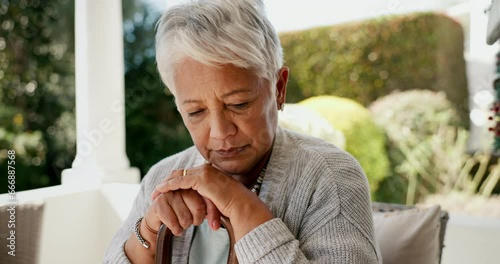 Old woman, walking stick and thinking as widow in retirement or depression in mental health, pain or sad. Elderly person, grief and healing as pensioner in home or memories, nostalgia or remembering
