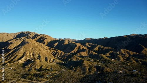 Drone shot panning left across mountains and desert in California photo
