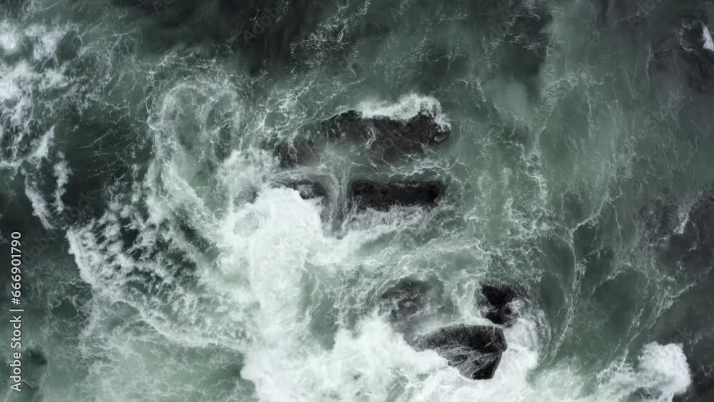 Topdown View Of Raging Waves Breaks On Rocks. Aerial Shot Topdown View Of Raging Waves Breaks On Rocks. Aerial Shot