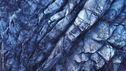 Aerial: descending into Glaciers deep crevasses and jagged ice formations, evidence of the impact climate change has on the constant movement and transformation of this natural wonder.