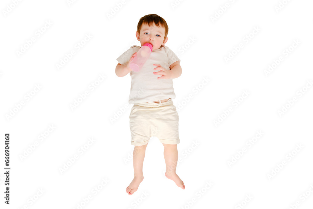 Happy baby drinks milk from bottle on studio, isolated on white background. Resting child eats formula, isolated on white background. Kid about two years old (one year nine months) Happy baby drinks milk from bottle on studio, isolated on white background. Resting child eats formula, isolated on white background. Kid about two years old (one year nine months)