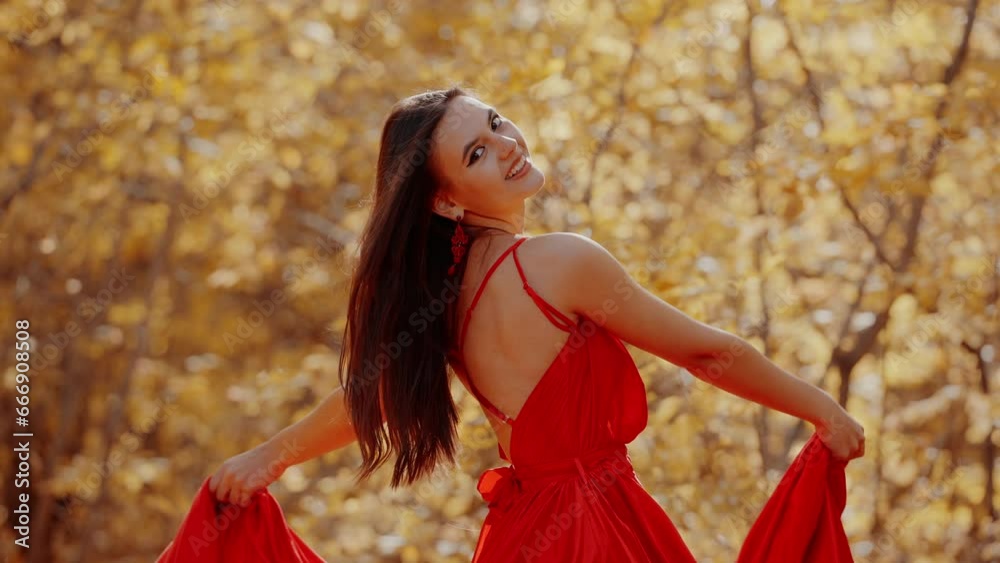 beautiful woman in a red dress poses in a bright autumn forest beautiful woman in a red dress poses in a bright autumn forest