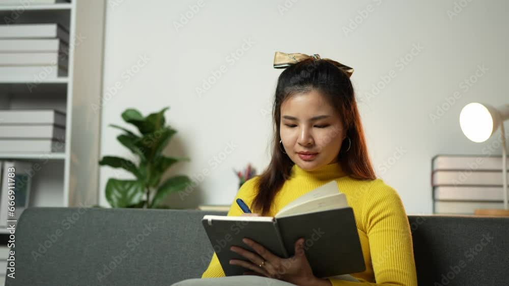 Asian businesswomen write on paper and use laptops to search data for work. Asian businesswomen write on paper and use laptops to search data for work.