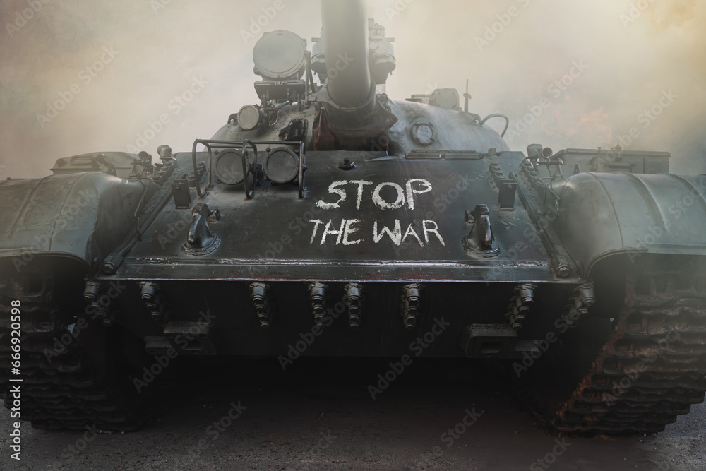 stop war the chalk inscription on the tank in fire and smoke. Anti-war concept.