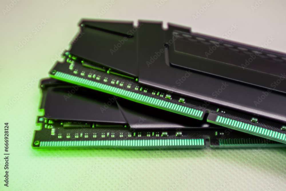 DDR4 DRAM memory modules. Computer RAM chip close-up on white in green light. Desktop PC memory parts for assemble DDR4 DRAM memory modules. Computer RAM chip close-up on white in green light. Desktop PC memory parts for assemble