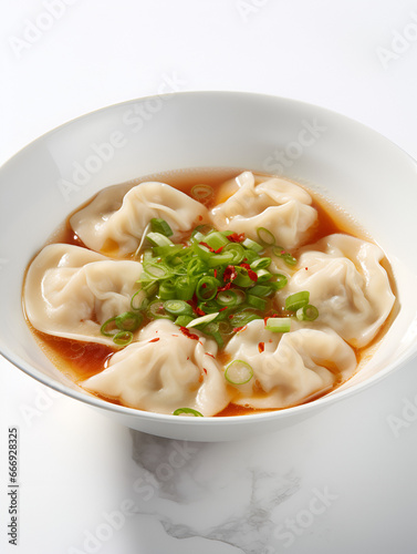 Delicious spicy soup with dumplings, traditional Chinese food on white background