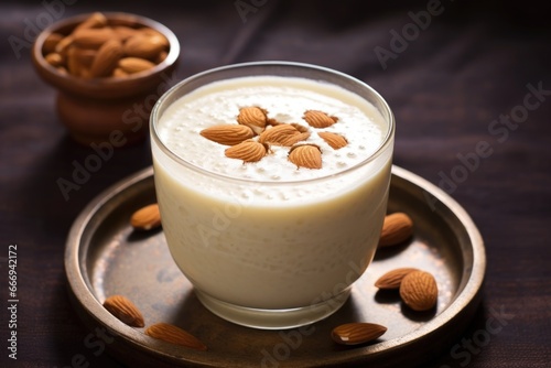 close-up view of badam milk garnished with almonds photo