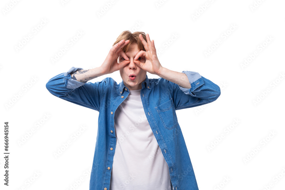 young redhead guy grimacing in blue shirt and white t-shirt young redhead guy grimacing in blue shirt and white t-shirt
