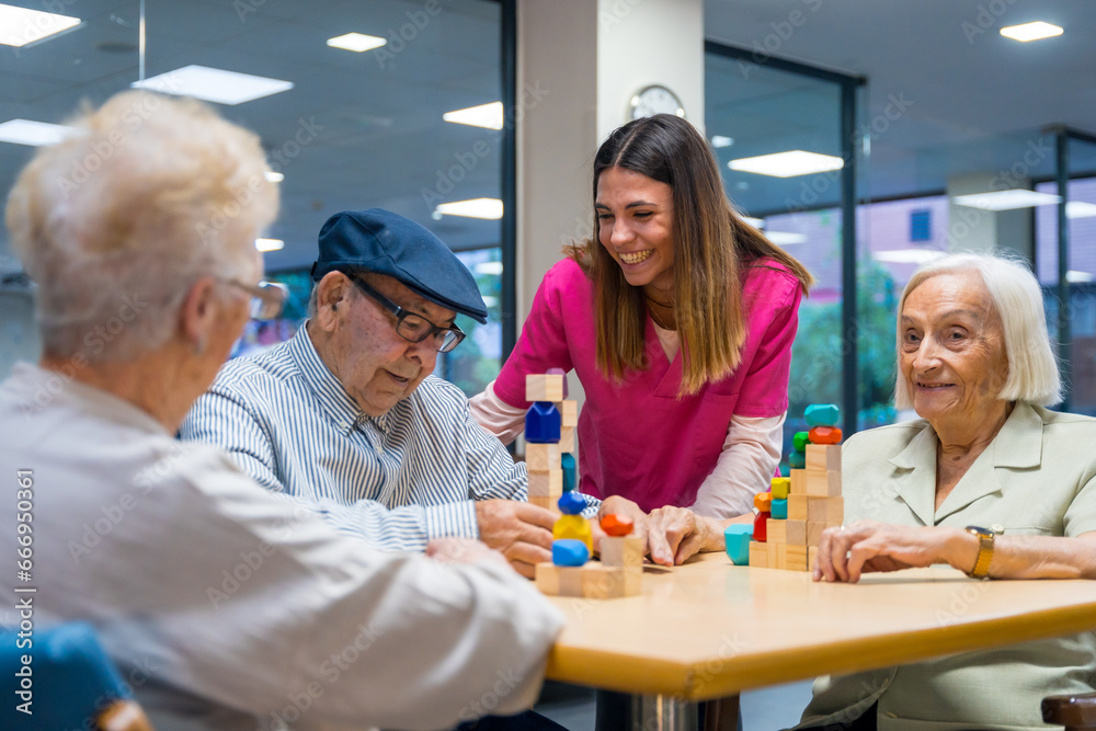 Nurse encouraging elder people playing skill games in a nursing home Nurse encouraging elder people playing skill games in a nursing home