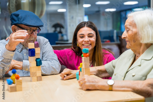 Nurse supervising seniors playing skill games in a nursing home photo