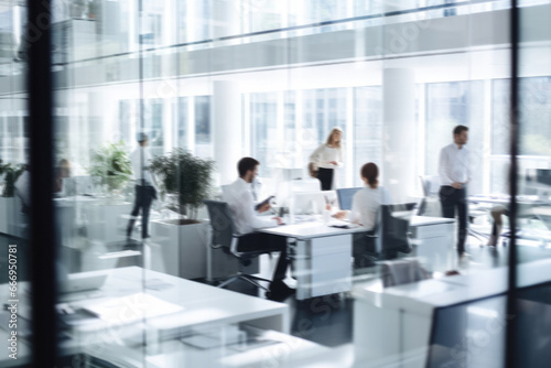 office workers in modern offices talking and sitting on computer