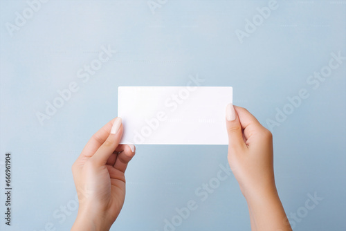 A woman holding an empty card from her both hands in a minimalist isolated copy space background, Hand hold empty white card mockup, Business branding minimal mock