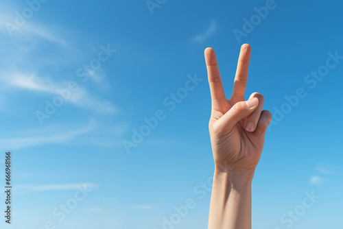 Generative AI Image of Two Fingers Symbolizing Peace with Blank Space on Bright Sky Background
