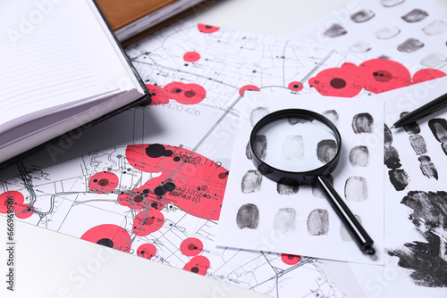 Books, magnifying glass with fingerprints on a white background photo