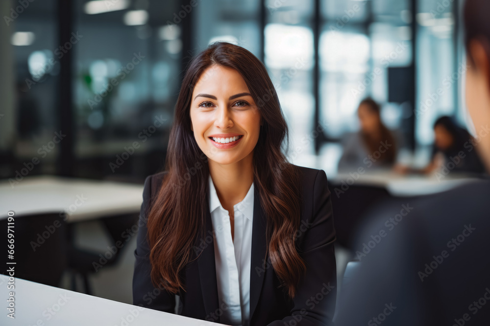 Candid portrait of a successful female business consultant in big firm. Young attractive woman smiling in office. Professional businesswoman in office Candid portrait of a successful female business consultant in big firm. Young attractive woman smiling in office. Professional businesswoman in office