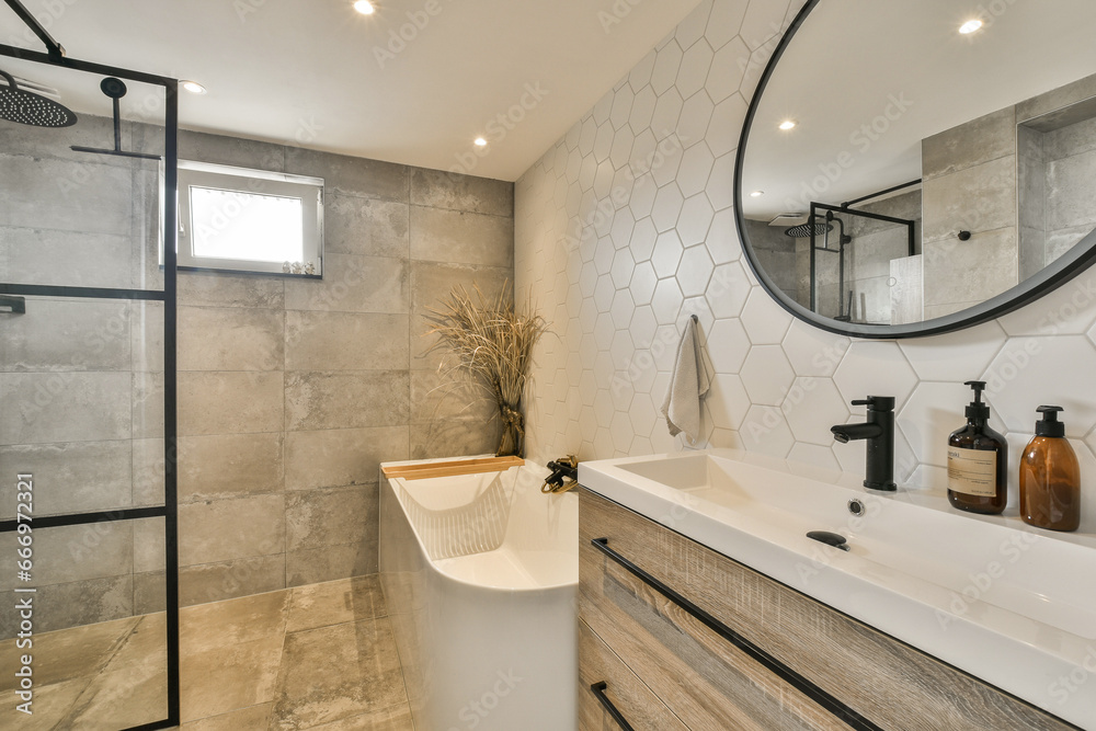 a modern bathroom with hexagon tiles on the walls, and a large mirror in the corner of the room a modern bathroom with hexagon tiles on the walls, and a large mirror in the corner of the room