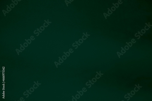 Dark green velvet fabric texture used as background. Emerald color panne fabric background of soft and smooth textile material. crushed velvet .luxury emerald tone for silk. photo