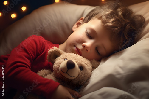 Cute little kid boy sleeping with teddy bear toy