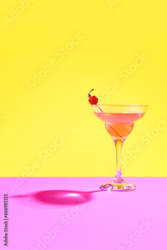 Vibrant margarita cocktail, tantalizingly decorated with plump cherry, entices from heart of opulent tropical retreat.