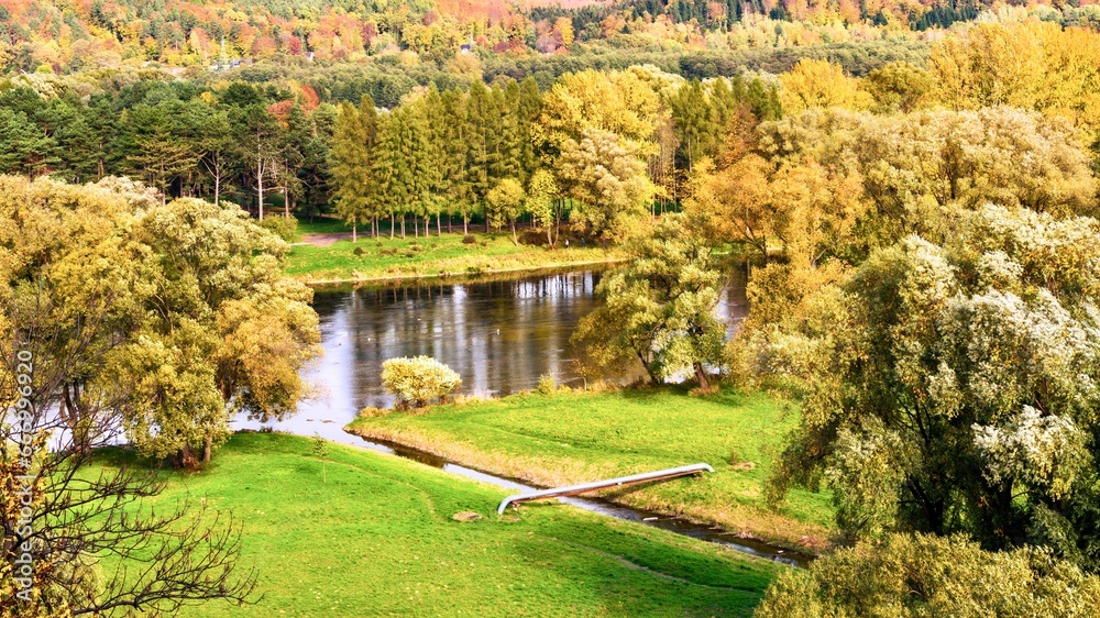 Beautiful autumn landscape with river and forest in Carpathian mountains, Sanok, Poland.