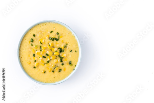 Corn soup in green bowl isolated on white background. Top view. Copy space